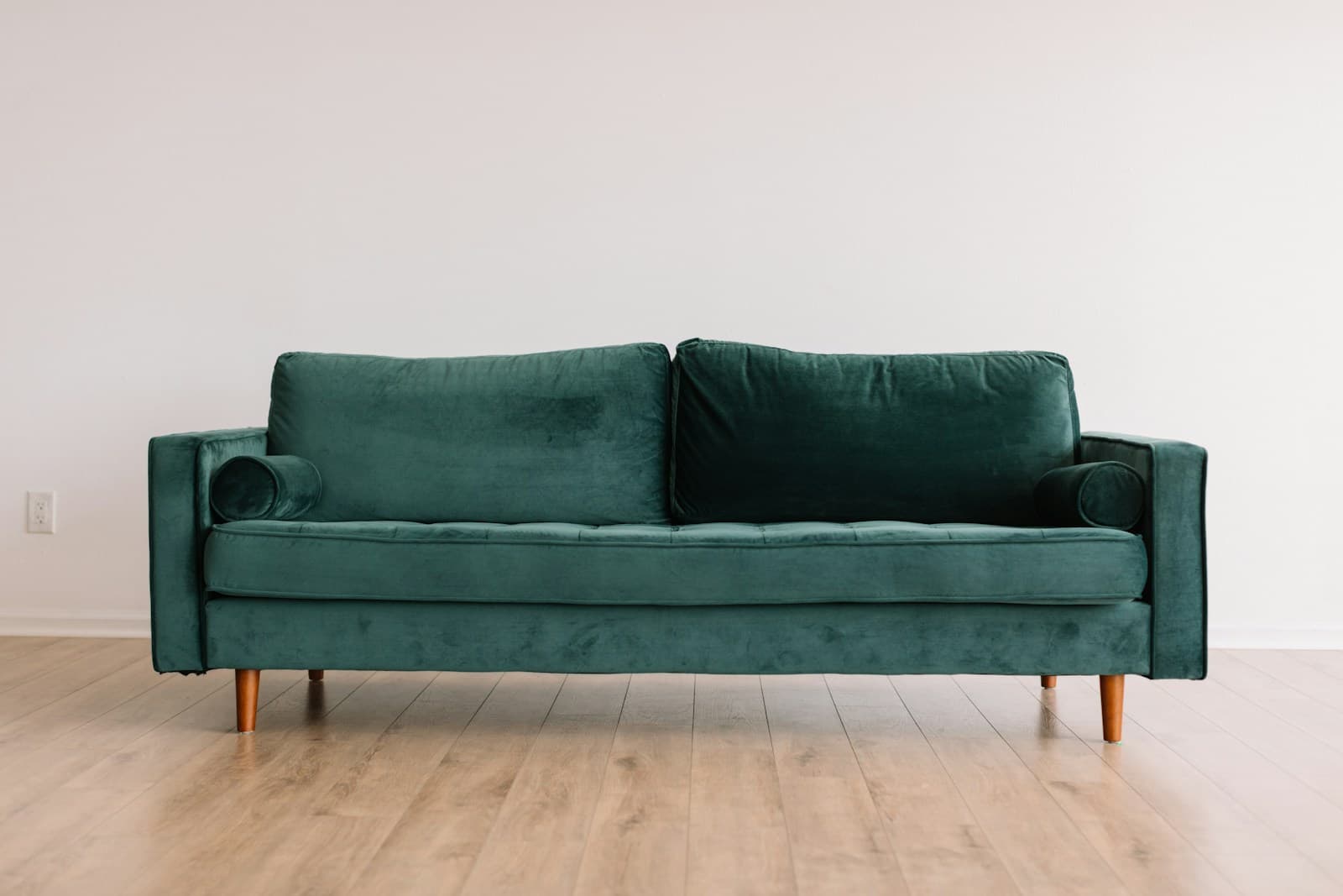 Emerald sofa against a white wall